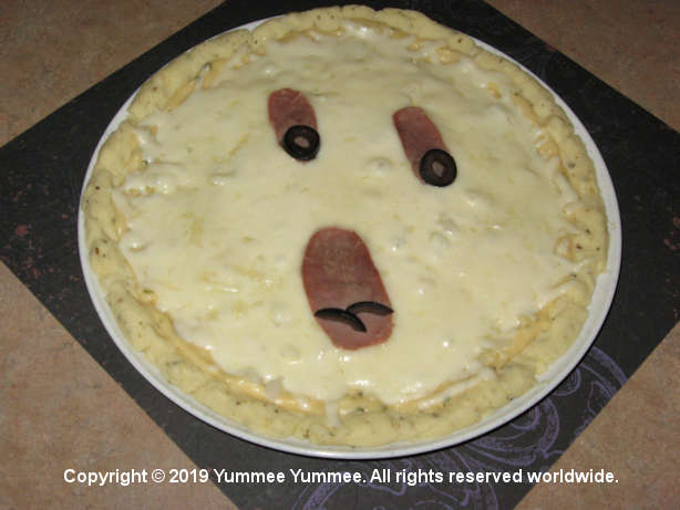 A ghastly ghostly gluten-free pizza - Halloween fun! How did we make the eyes and mouth?