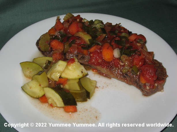 Healthy veggies smother the beef while it cooks on low oven heat for flavor and tenderness.