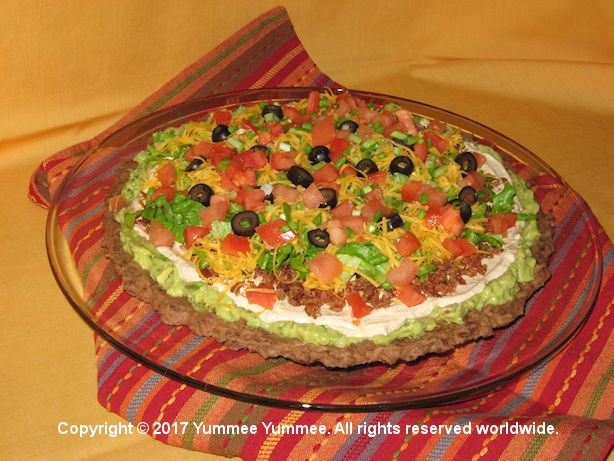 Layered Fiesta Dip is a great party dip. Open the tortilla chips and let your party guests have fun!