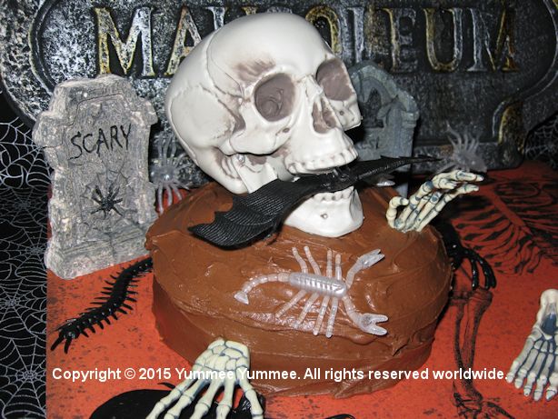 Creepy & fun cake decorating with inexpensive props - skulls, bats, spiders, old halloween costumes, headstones, skeleton parts ...