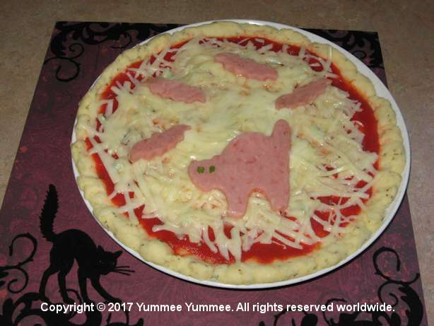 A wickedly scary cat on your pizza from the microwave. A wickedly scary cat on your pizza from the microwave.